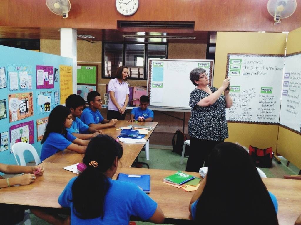 Woman teaching children.
