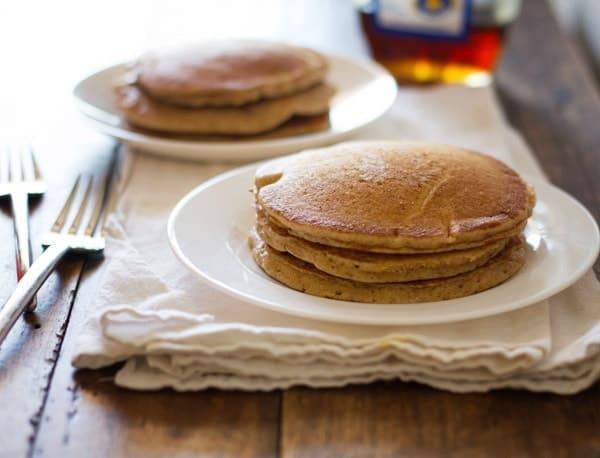 Whole wheat pancakes stacked on a plate.