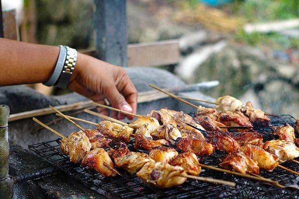 Filipino chicken barbecue on a grill.