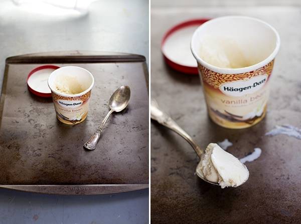 Scratched, stained cookie sheets under a tub of ice cream.