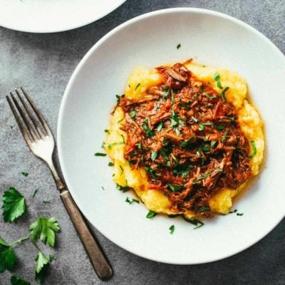 Crockpot Braised Beef Ragu with Polenta in a bowl.