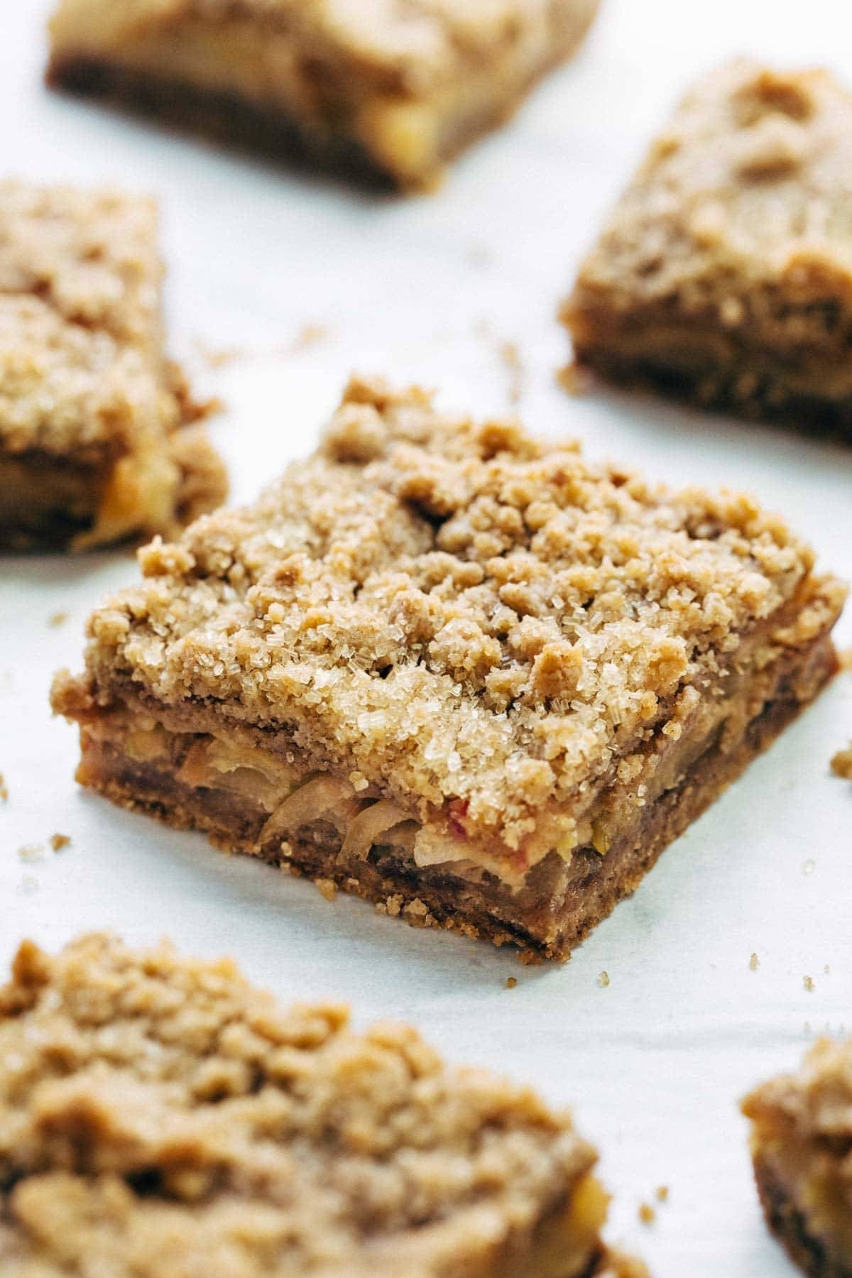These layered bars are so simple! Loaded with homemade caramel and apples. Caramely apple layer tucked in by a brown sugar-y crust on both sides. | pinchofyum.com These layered bars are so simple! Loaded with homemade caramel and apples. Caramely apple layer tucked in by a brown sugar-y crust on both sides. | pinchofyum.com