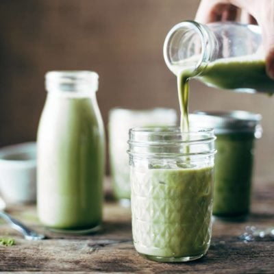 Ice Matcha Green Tea Latter being poured into a glass.