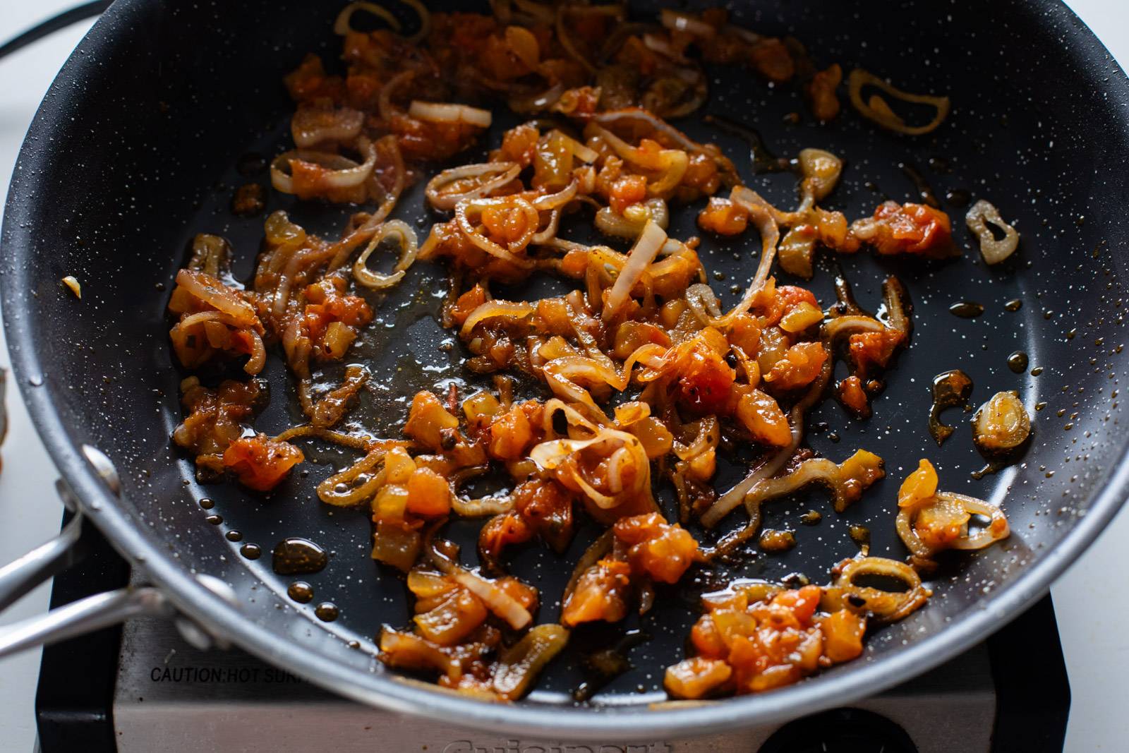 Cooking shallots in a skillet.