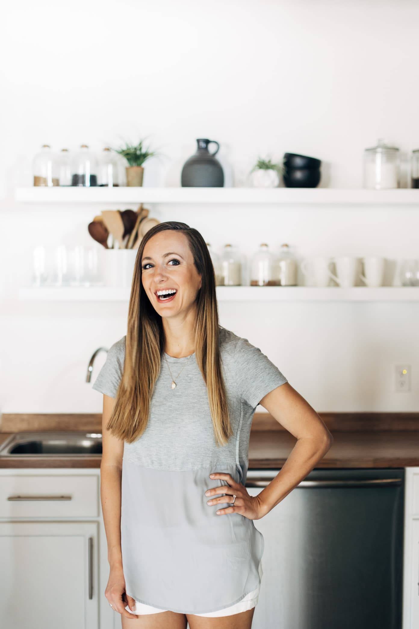 Woman with her hand on her hip in a kitchen.