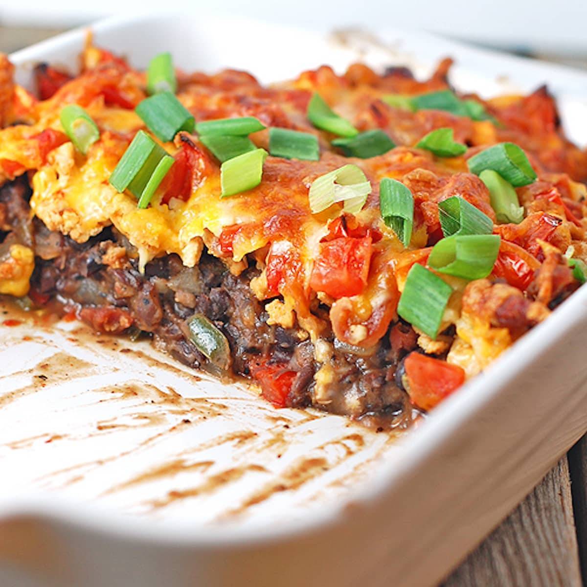Black bean casserole is made with ground turkey, black beans, peppers, and cheese.