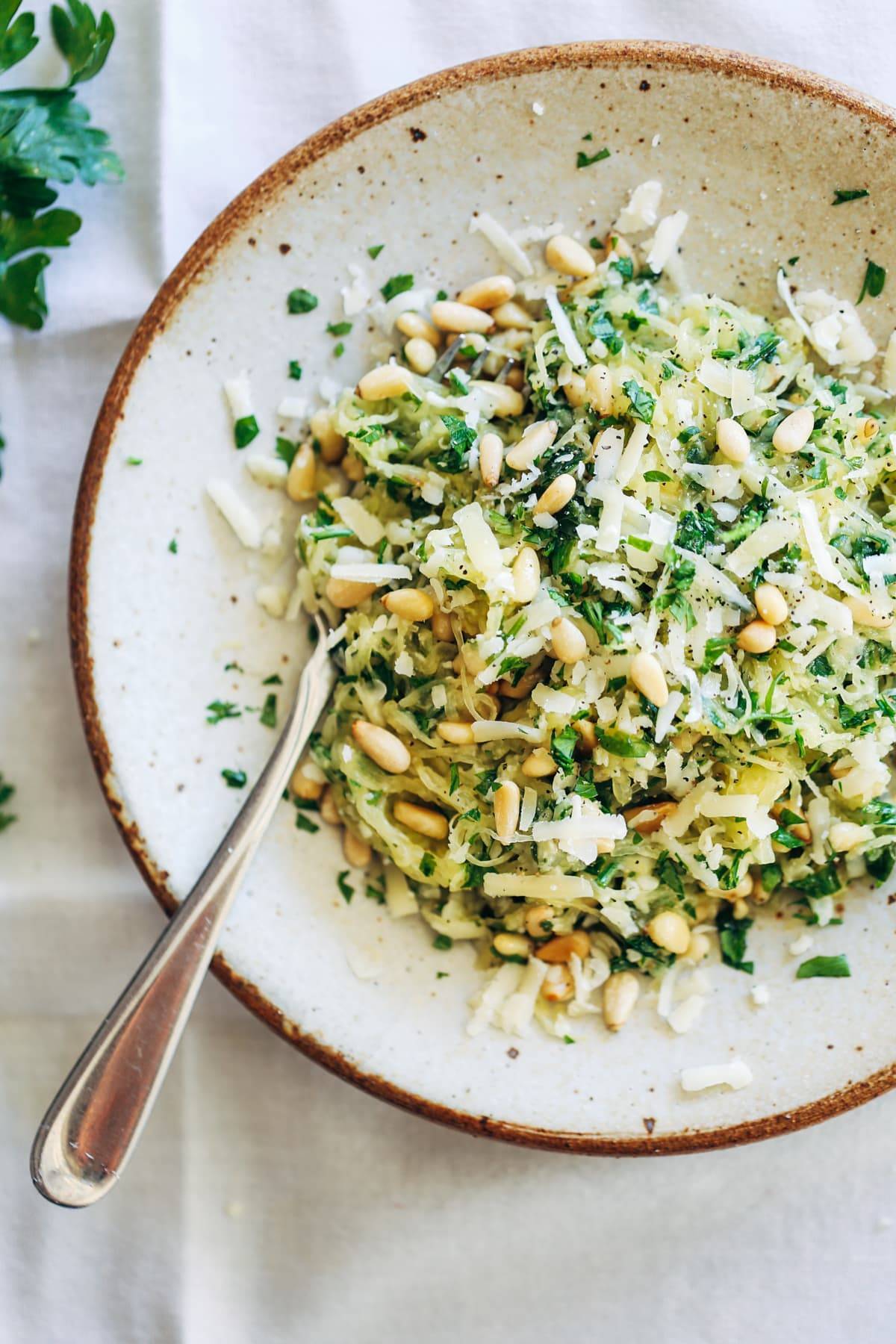 Garlic Spaghetti Squash with Herbs on a plate with a fork.